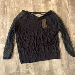 Black dressy top with see-through polkadot sleeves, crisscross backing large